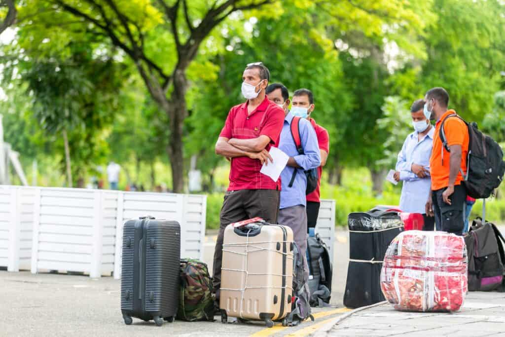 Travellers in Seville waiting with suitcases