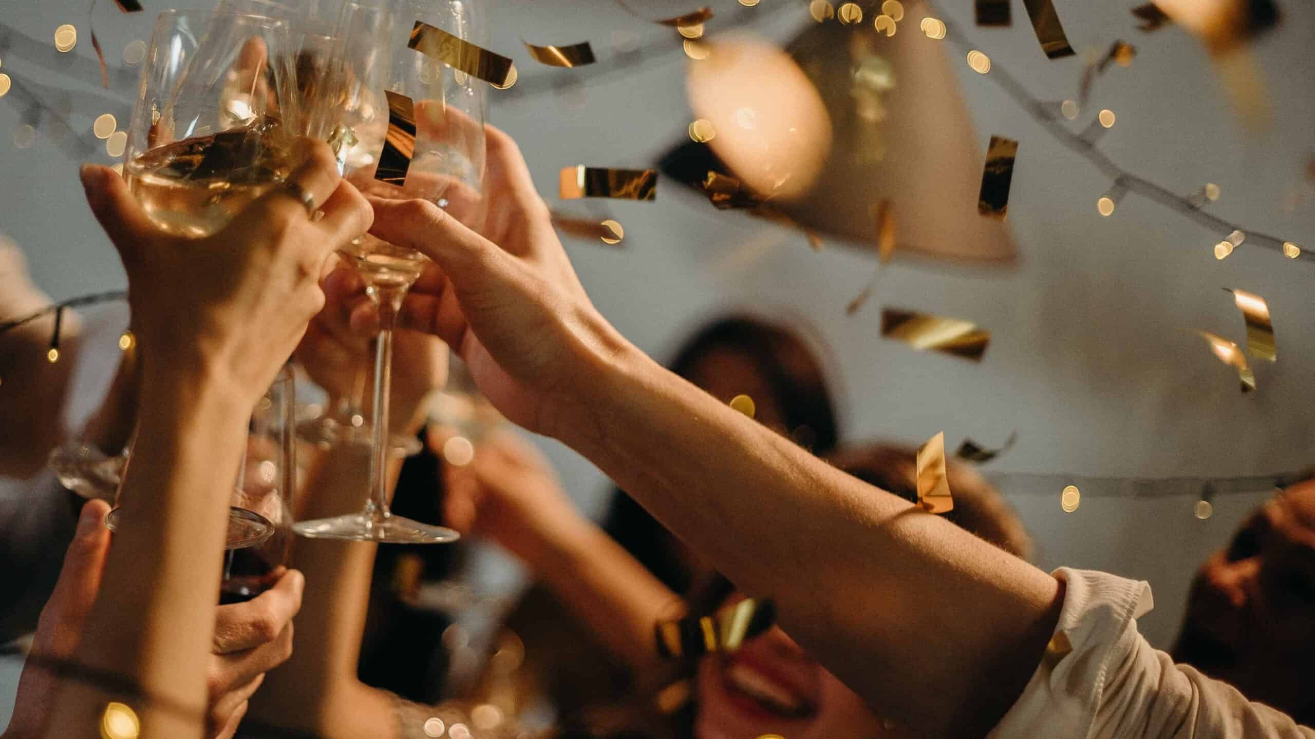 People cheering with drinks on New Year’s Eve in Seville