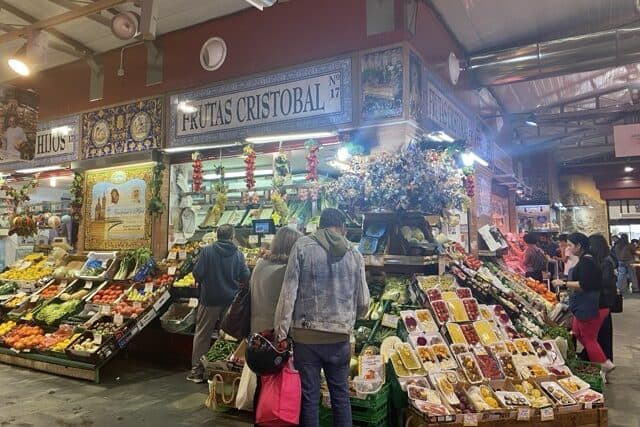 Inside Triana Market in Seville, with stalls selling fresh produce