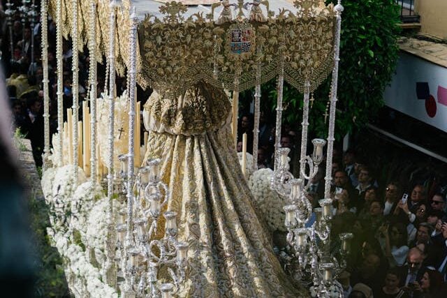 Paso carried through the streets during Semana Santa in Seville with crowds watching
